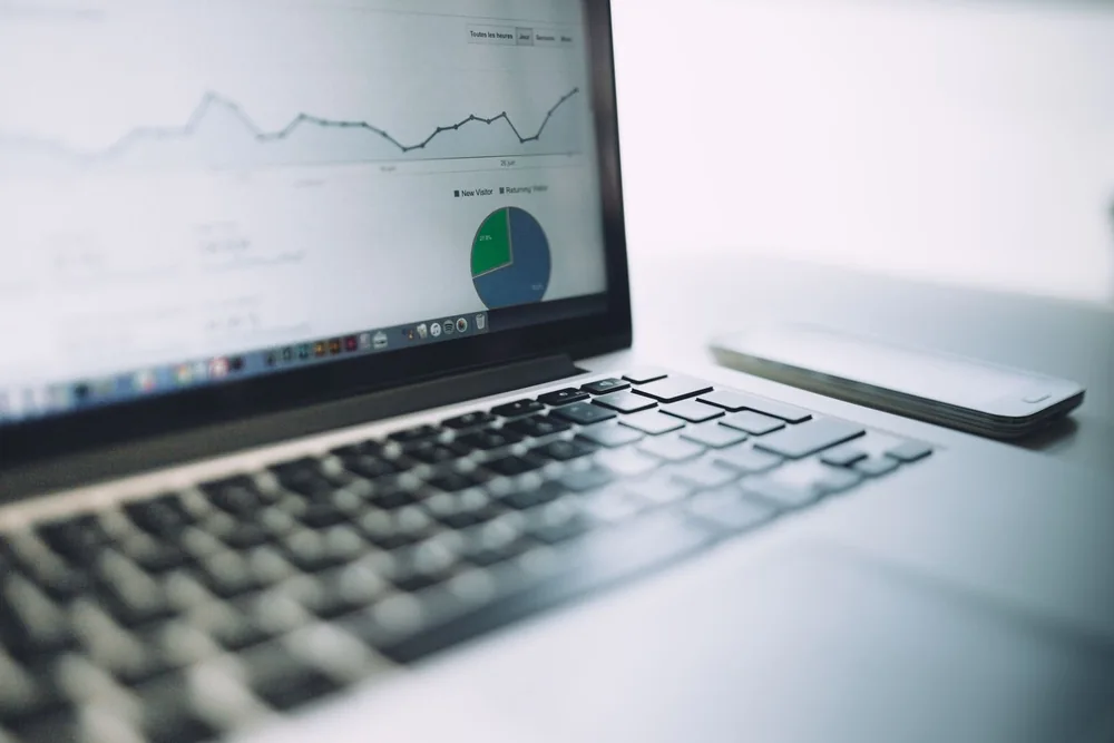 Reviewing charts and business reporting on a laptop